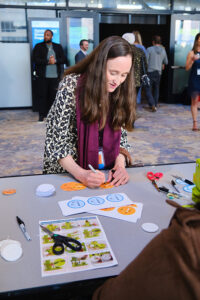 A women leaning over a table writing something