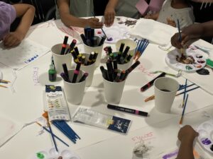 Paint and art supplies scattered across a table