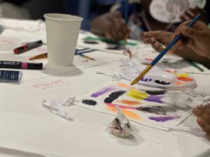 Paint and art supplies scattered across a table