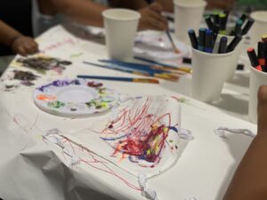 Paint and art supplies scattered across a table